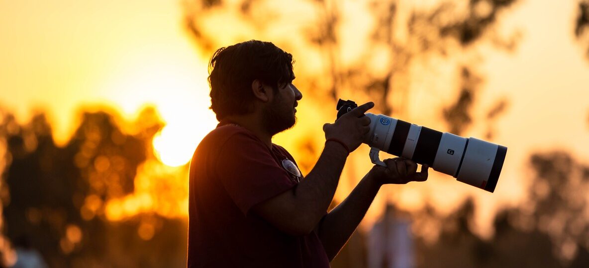 best kenya safari for photographers - wildlife photographer in open vehicle, Masai Mara