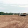 Fly in safari Kenya: light aircraft landing on a bush airstrip in the Masai Mara at sunrise