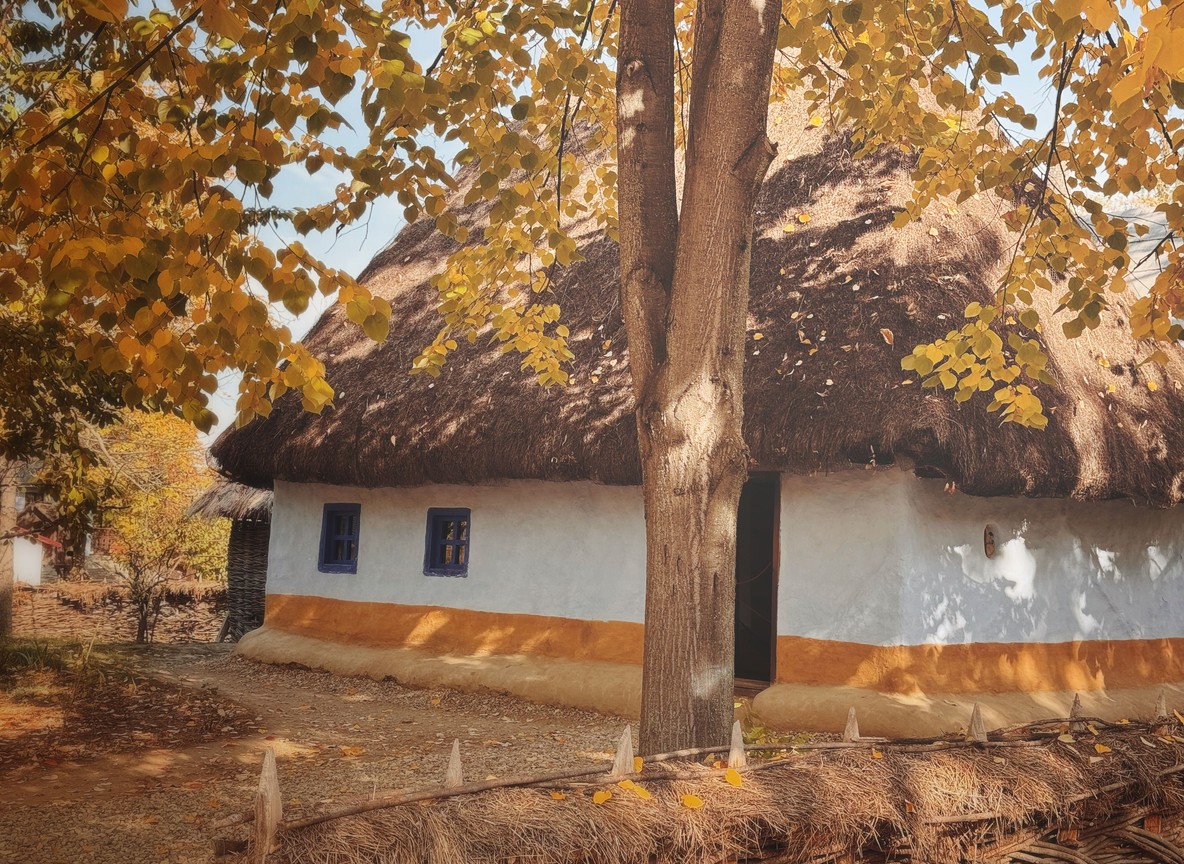 A thatched Amboseli Sopa Lodge cottage veranda overlooking open savannah grassland
