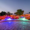 A luxury tented suite with a private deck overlooking the Maasai Mara plains at golden hour