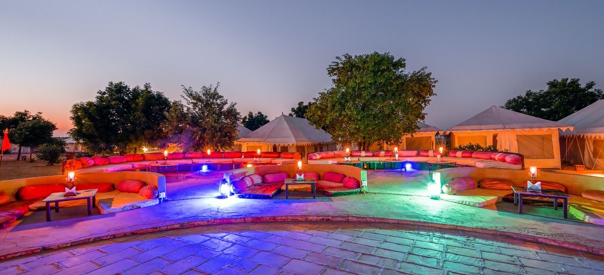 A luxury tented suite with a private deck overlooking the Maasai Mara plains at golden hour