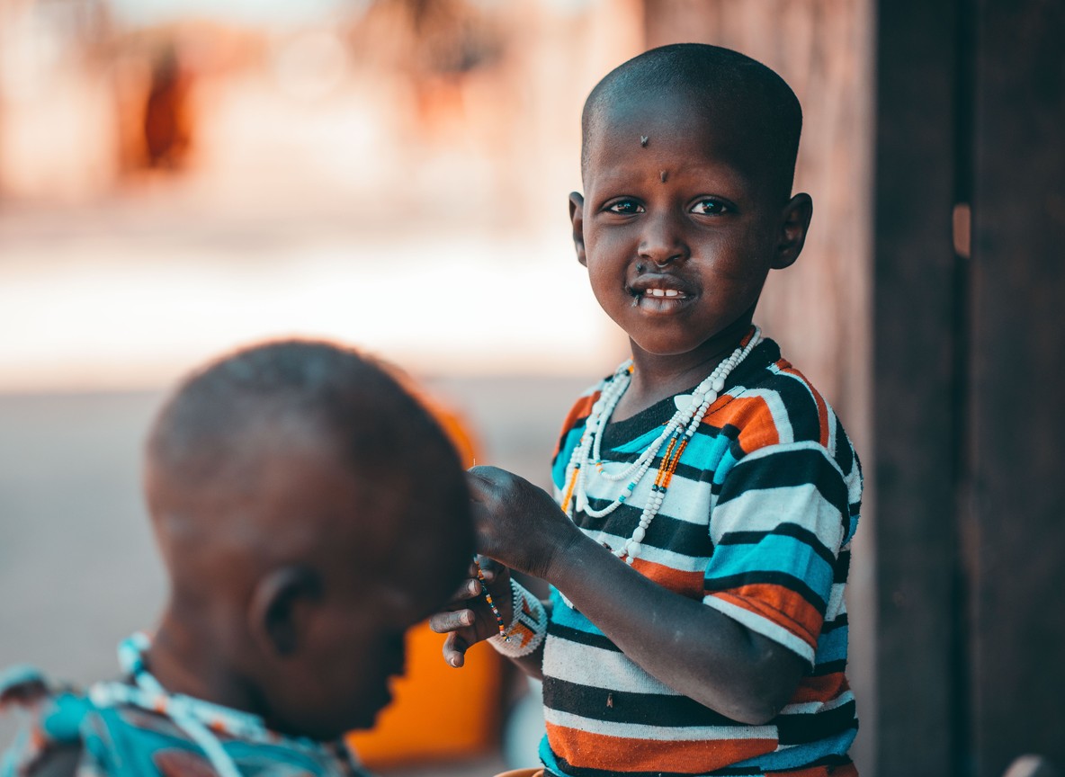 Maasai children in beaded necklaces in a Kenyan community conservancy village