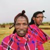 Maasai warriors in traditional red shukas performing the adumu jump dance during a cultural festival celebration in Kenya