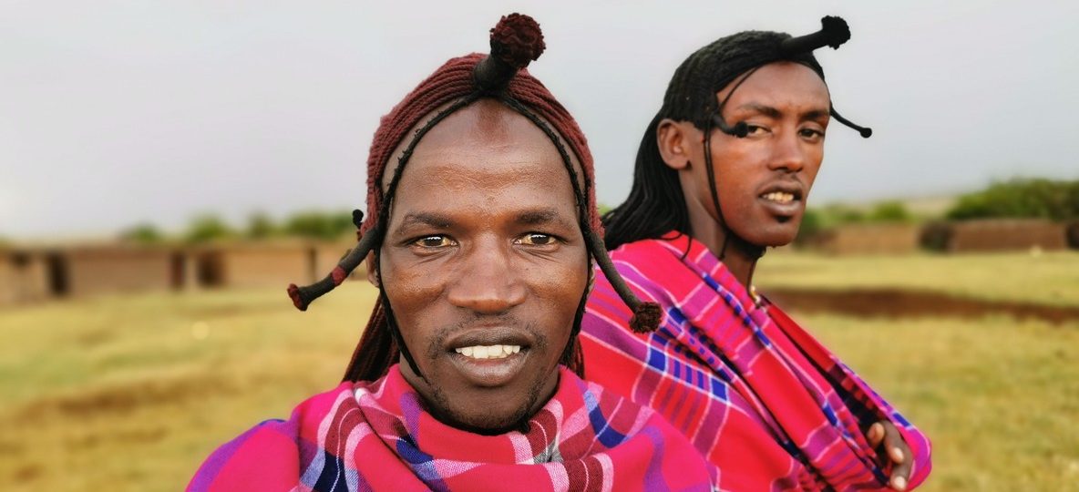 Maasai warriors in traditional red shukas performing the adumu jump dance during a cultural festival celebration in Kenya