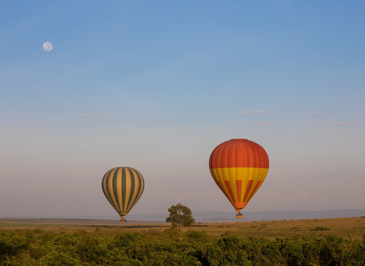 A hot-air balloon drifting over the plains at sunrise, a popular add-on activity for Kenya corporate incentive groups