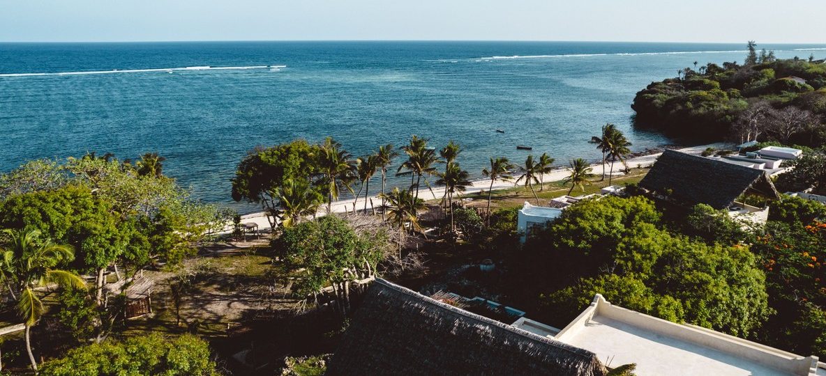 Kenya ocean conservation summit coastline in Mombasa with turquoise water, coral reefs, and dhow boats near the shore