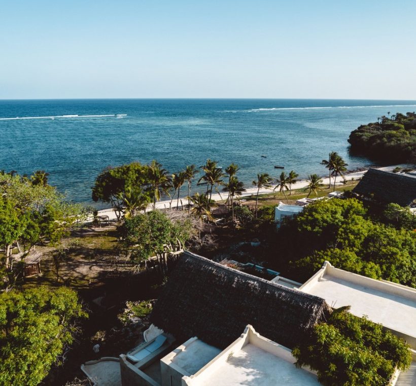 Kenya ocean conservation summit coastline in Mombasa with turquoise water, coral reefs, and dhow boats near the shore