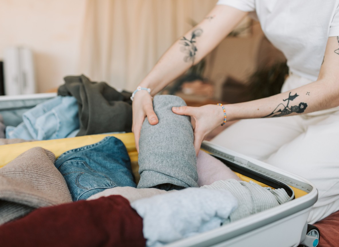 Neutral-toned safari clothing folded and organized in packing cubes