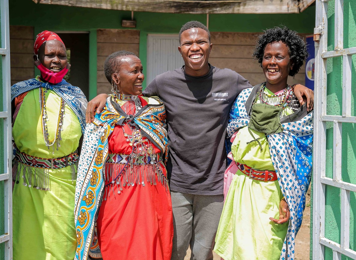 Maasai community members and a Trunktrails Safaris guide at a conservancy boundary near the Maasai Mara