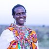 Masai Mara, acacia trees and tented structures