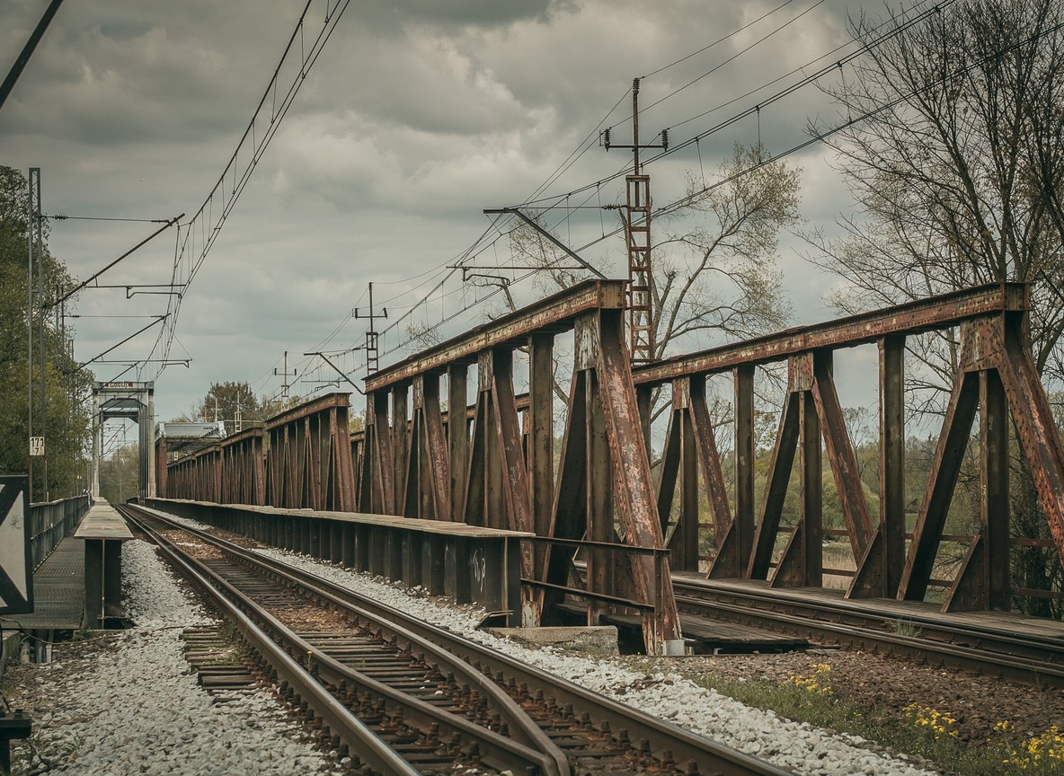 Old railway carriages and tracks in a weathered rail yard, a relic of Kenya's railway history