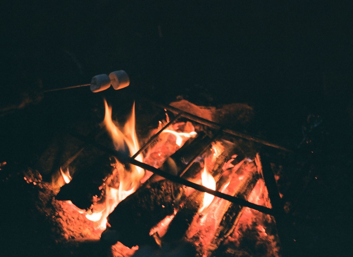 A campfire glowing under the stars at a Kenya safari camp in the evening