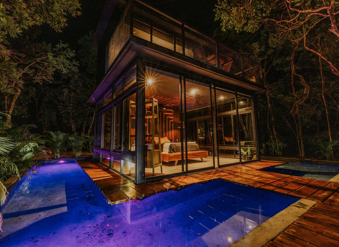 Private luxury safari tented lodge overlooking a Laikipia waterhole at dusk